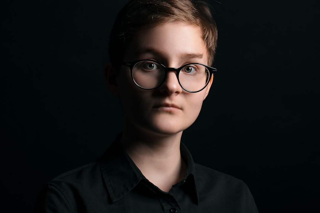 Studio portrait of a woman with short hair and glasses