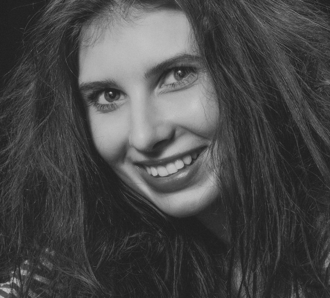 Studio portrait of a smiling woman with long hair